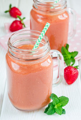 Healthy smoothie with strawberry, mango and banana in glass jars