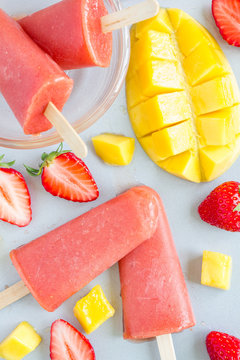 Homemade strawberry-mango popsicles top view