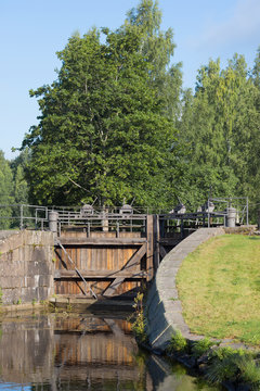 Ancient wooden gate of the old lock "Mustola" in the Saimaa Canal. Finland