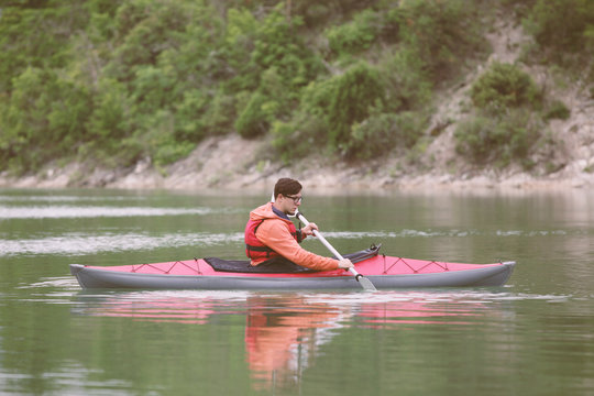 Kayaker paddling on the lake. Toned Image.