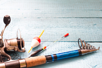 Fishing tackle on wooden blue background
