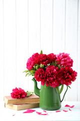 Bouquet of red peony flowers on a white wooden table