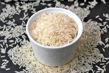Basmati rice in the bowl on the black background