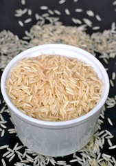 Basmati rice in the bowl on the black background