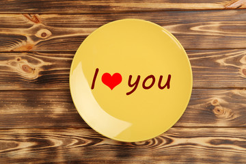 Yellow plate on a brown wooden table