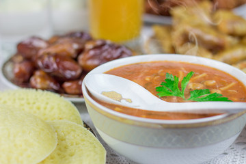 Bowl of Moroccan harira soup,chebakia, dates for iftar