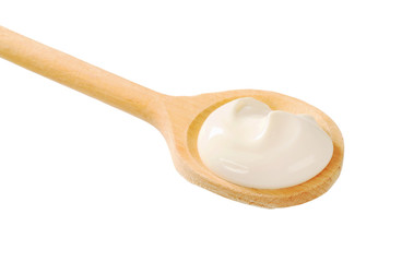 Sour cream on a wooden spoon
