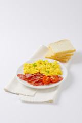 scrambled eggs and cooked bacon