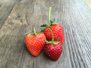 Fresh strawberries on old wooden background