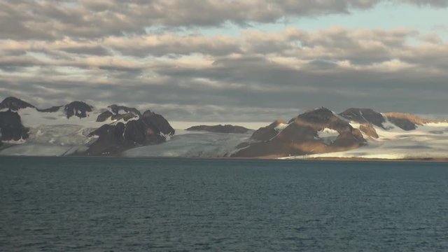 Snowy mountains and the sea in Arctic. Iceland. Fantastic wonderful amazing video grenland nature iceland. Lovely shooting the life of nature, seaside and mountains.