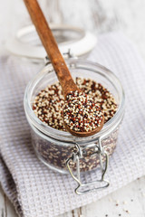 quinoa seeds on a wooden spoon