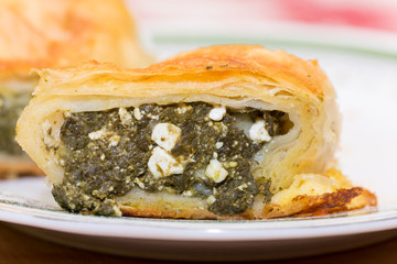 Macro selective focus spinach pie on the plate