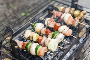 Selective focus on the meat and vegetables on the grill