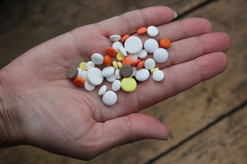 Medicinal pills on the palm.