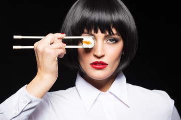 Fototapeta premium Sexy woman in wig holding sushi