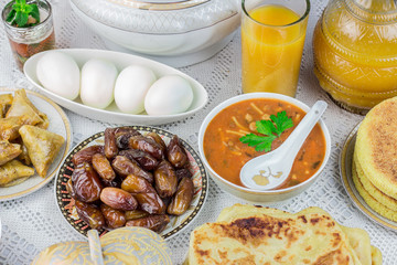 Bowl of Moroccan harira soup,chebakia, dates for iftar