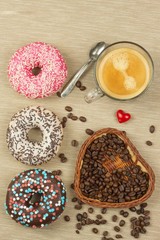 Fresh hot coffee and fresh donuts. Traditional sweets with coffee. Calorie junk food. Fresh unhealthy breakfast.
