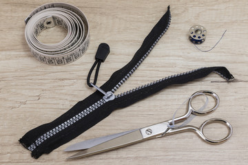 Sewing tools and sewing kit on a wooden background
