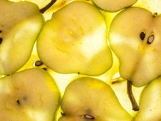 Naklejka na ściany i meble background of ripe back lit pear slices