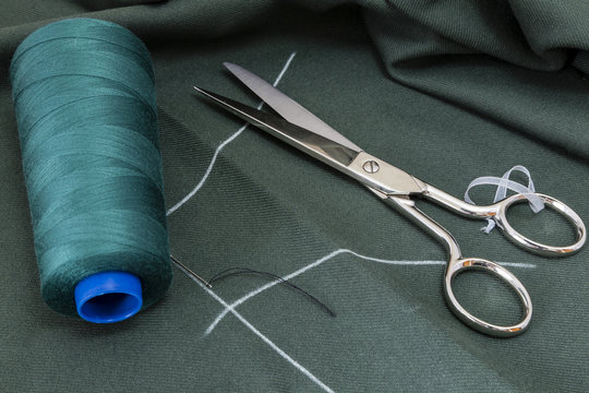 Sewing tools and sewing kit on a green cloth
