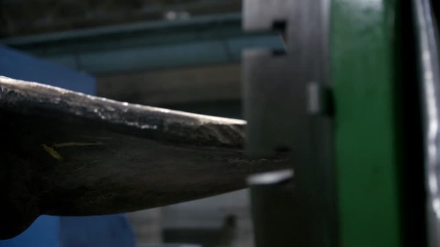 The big metal ship propeller. screw is spinning inside modern shipyard