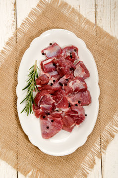 preparation of raw deer goulash with rosemary, peppercorn