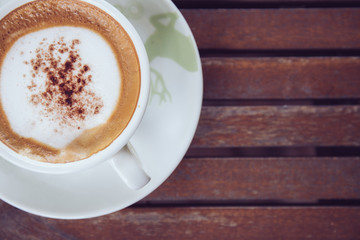 Latte coffee on top view with vintage style on wooden table in cafe