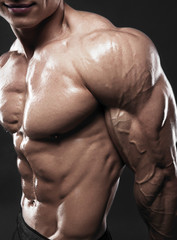 Fototapeta na wymiar Muscled male model showing his biceps