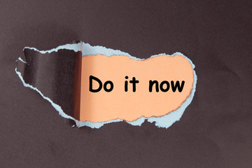 The word Do it Now appearing behind torn paper, burlap. Motivational concept