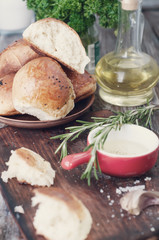 Fresh bread and rosemary . Toned photo