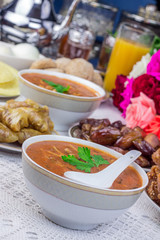 Bowl of Moroccan harira soup,chebakia, dates for iftar