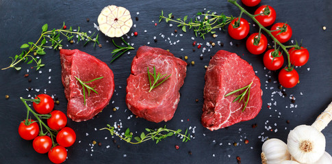 Fresh Raw Beef steak Mignon, with salt, peppercorns, thyme, garlic.
