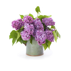 The lush bouquet of lilac in a ceramic vase..