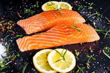 fresh raw salmon fillet with aromatic herbs, spices.