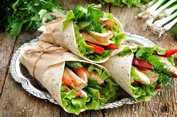 Tortilla roll with grilled chicken, tomato, cucumber, peppers, lettuce.