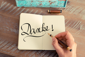 Handwritten text in German "Danke"  - translation : Thank You