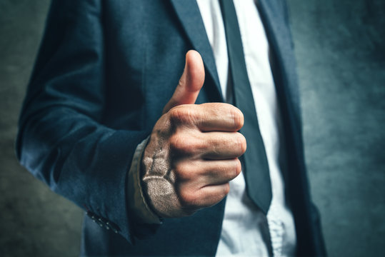 Gaining bosses approval, businessperson gesturing thumb up
