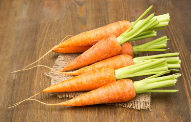 Fresh carrots at wooden table