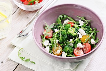 Broccoli salad with tomatoes,arugula and feta cheese.Selective focus
