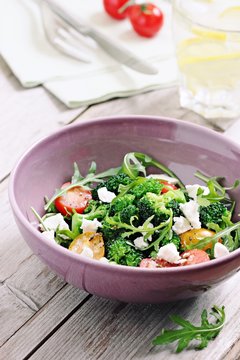 Broccoli salad with tomatoes,arugula and feta cheese.Selective focus