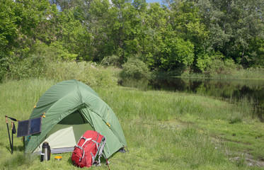Camping in the woods on the banks of the river.