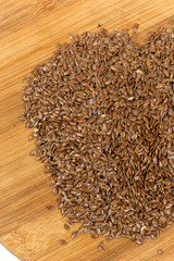 Flax seeds on the wooden board