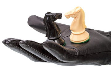 Black gloves and two chess horse © ra3rn