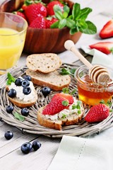 Healthy breakfast with wholegrain bread,cottage cheese and fresh berries.Selective focus 