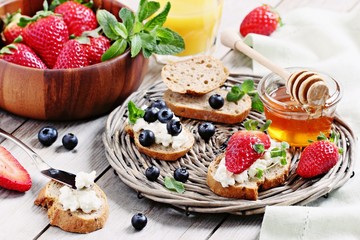 Healthy breakfast with wholegrain bread,cottage cheese and fresh berries.Selective focus 