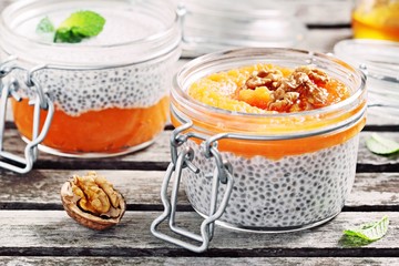 Overnight chia seeds pudding with pumpkin puree in glass jar. Healthy breakfast to go. Superfoods concept