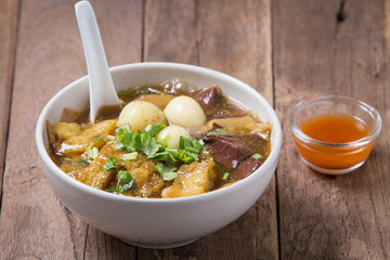 Braised Fish Maw with sauce for healthy on wood background.