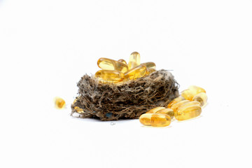 Cod liver oil omega 3 gel capsules in sparrow nest
