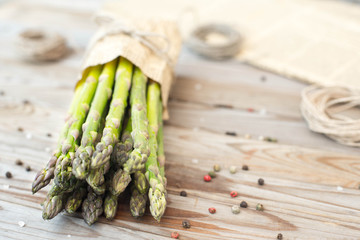 Fresh asparagus on wooden background.
