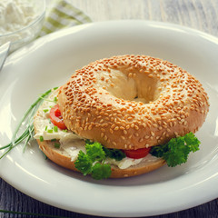 Bagels wtih cream cheese, tomatoes and chives for healthy snack